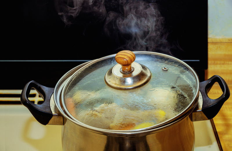 Chicken Homemade Broth With Meat On Bone And Vegetables In A Metal On Gas Stove
