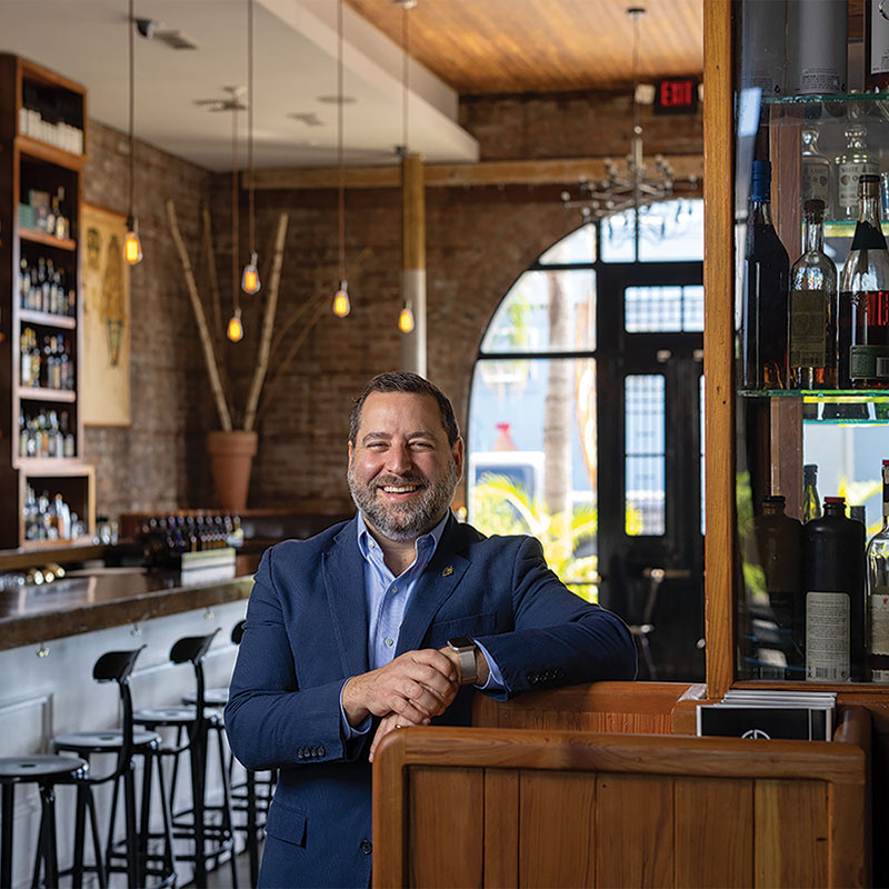 Cure Founder Neal Bodenheimer leaning on counter in Cure bar 