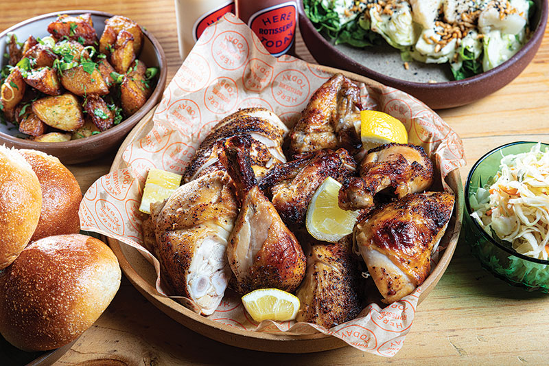 Here Today's Rotisserie chicken, cut up in a basket and with lemons as garnish