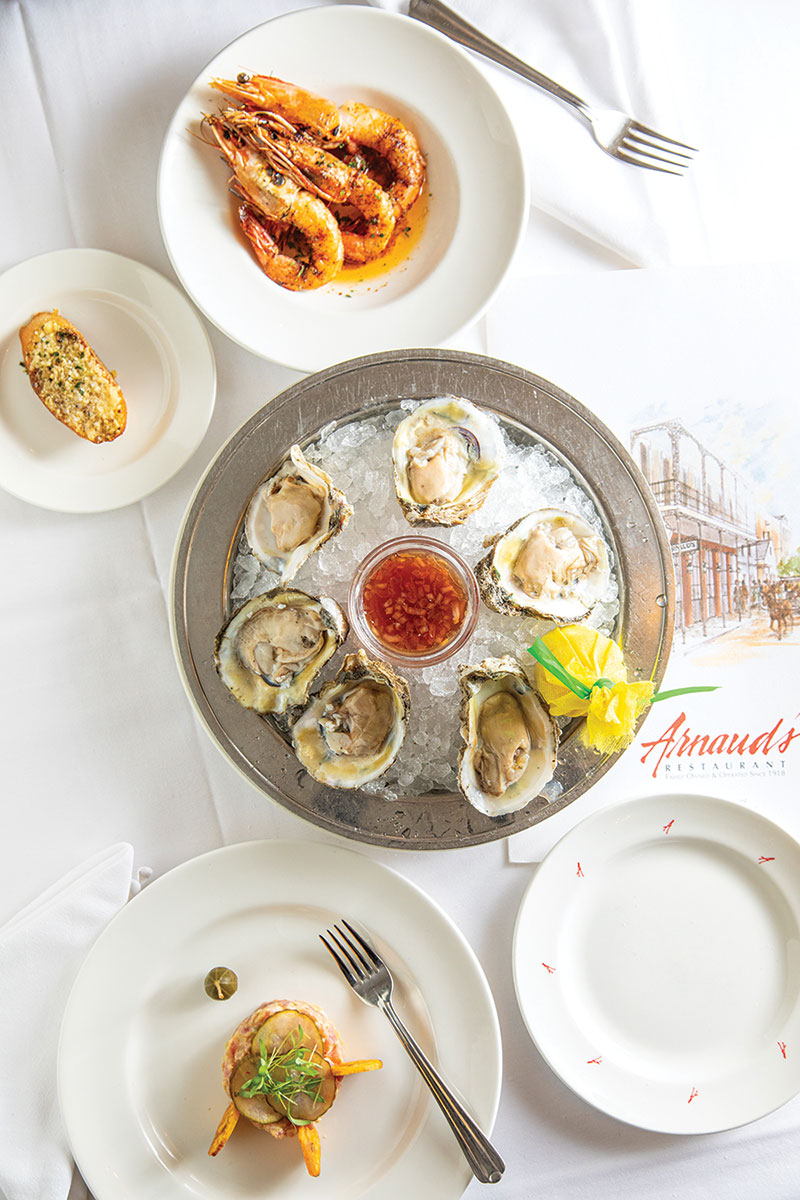 Oysters surrounded by other various dishes.