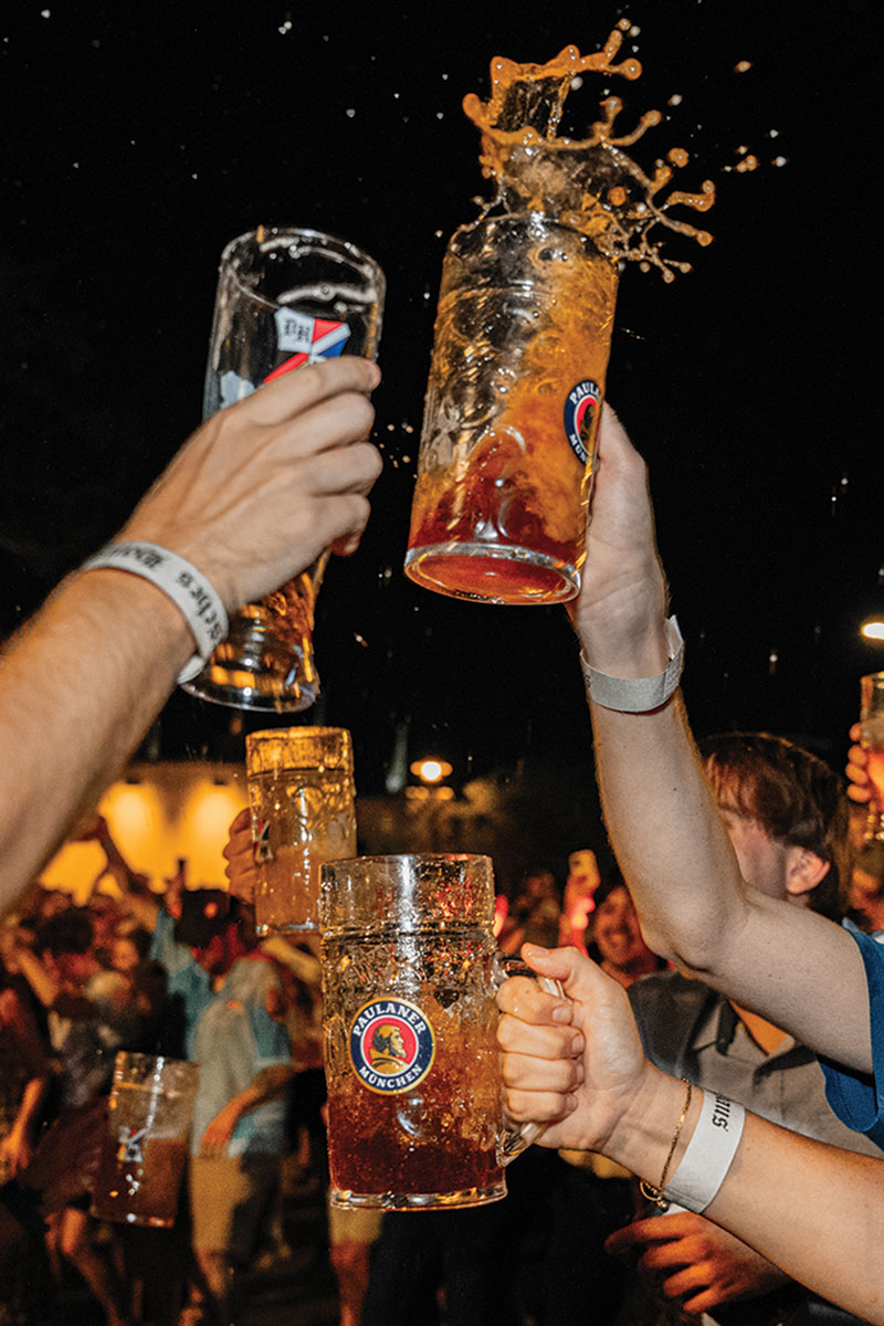 Bar Tab: Oktoberfest, Louie Louie's New Flavor & More Multiple hands holding tall glasses of beer, clinking them