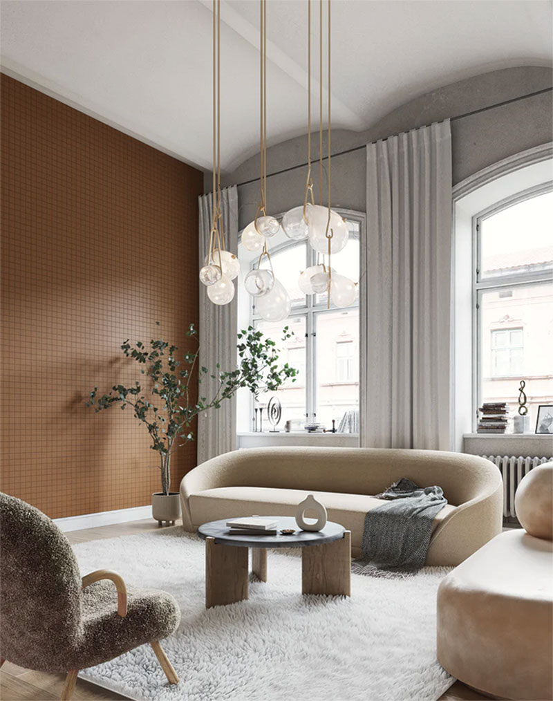 Modern living room with brown wallpaper and a cream couch.