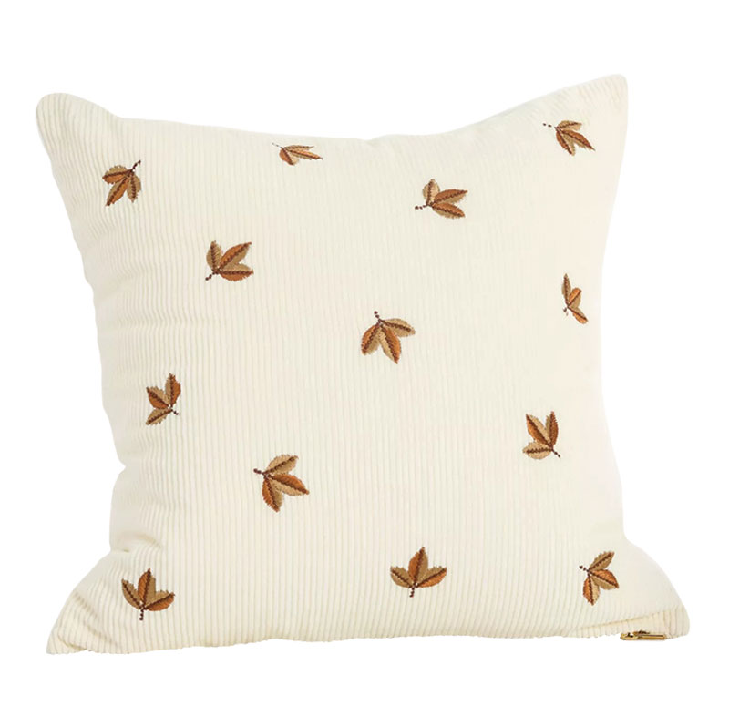 Cream colored pillow with autumn leaves embroidered all over