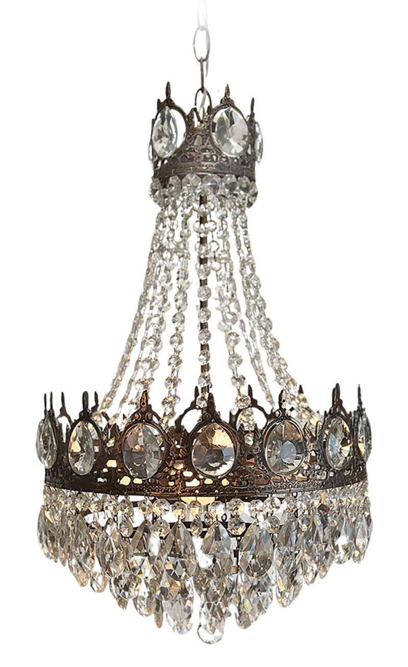 A sophisticated way to sparkle, a vintage French Empire-style crystal chandelier, showcasing ornate bronze tone metalwork and cascading strands of faceted glass beads, makes a striking centerpiece in any foyer. Bevolo Gas & Electric Lights, 318 Royal St., 504-522-9485, bevolo.com