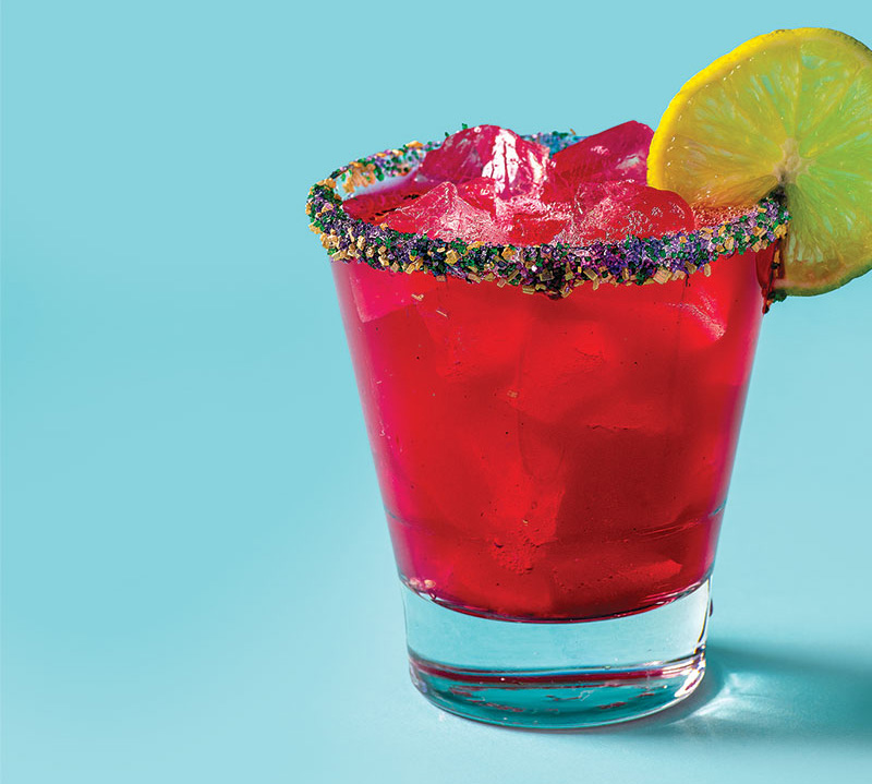 Mr. B’s Red mixed drink with a sugared rim and a lime garnish