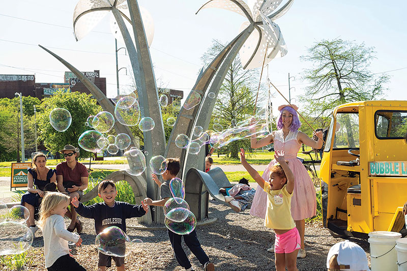 Celebration at the Greenway with children playing with bubbles