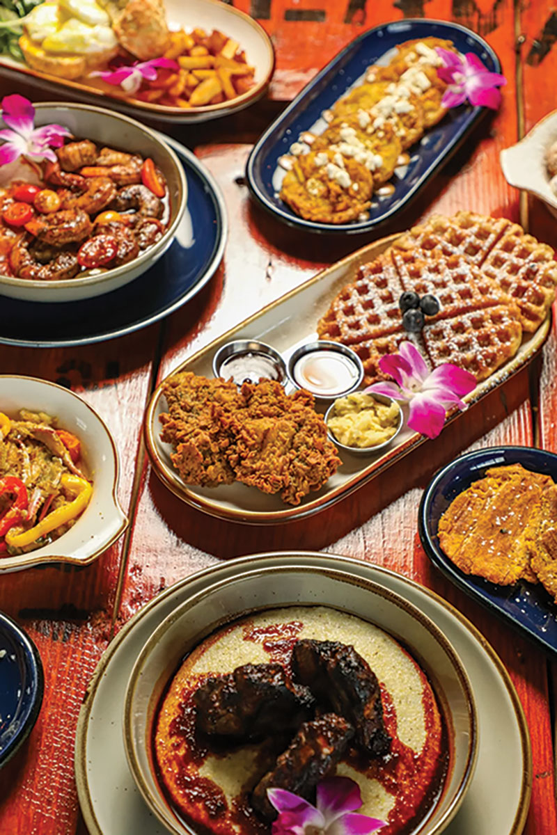 A spread of Jamaican food in multiple bowls and plates